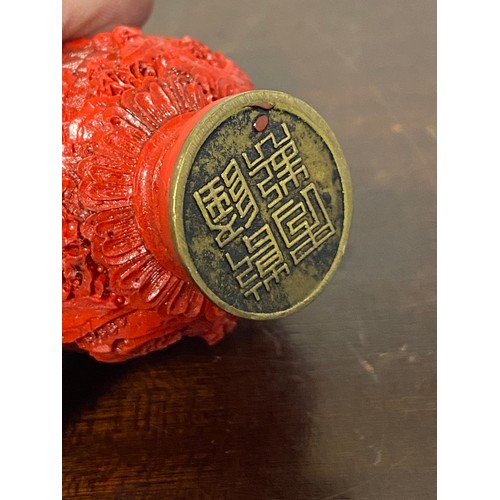 58 - A Chinese cinnabar lacquer snuff bottle, continuously carved with figures in a landscape, four chara... 