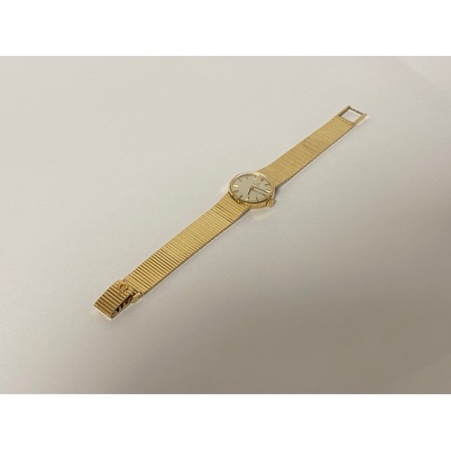 11 - A lady's 9ct gold Omega wristwatch, the signed circular dial to flexible 9ct gold bracelet strap -