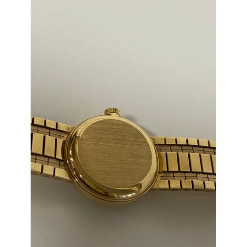 11 - A lady's 9ct gold Omega wristwatch, the signed circular dial to flexible 9ct gold bracelet strap -