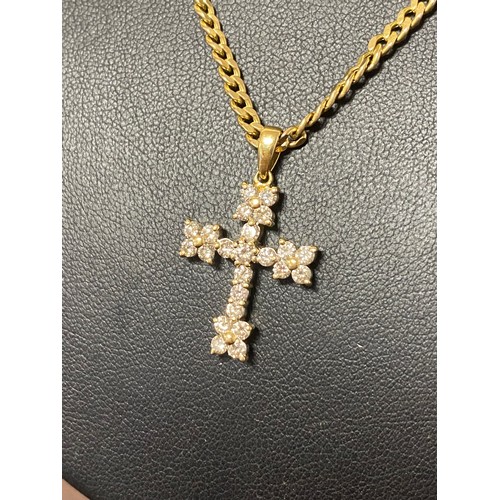 13 - An 18ct gold diamond set cross pendant, on 9ct gold chain -