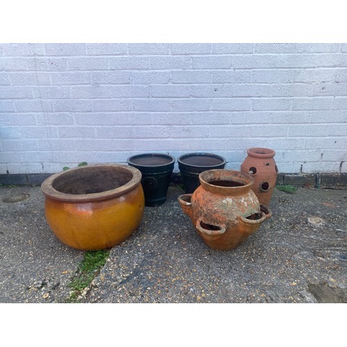 357 - A pair of green glazed garden pots, another planter and two strawberry planters -