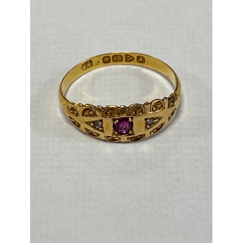 21A - An 18ct gold ring, set with an oval ruby and two rose cut diamonds -