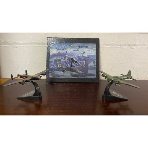 258 - A decoupage slate wall clock, decorated with a Spitfire and airmen, and two model planes -