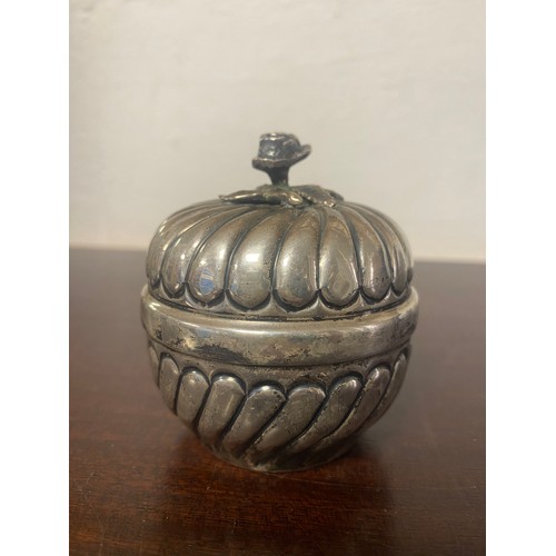 56 - A white metal pomander style box and cover, with floral knop, the body and cover gadrooned -