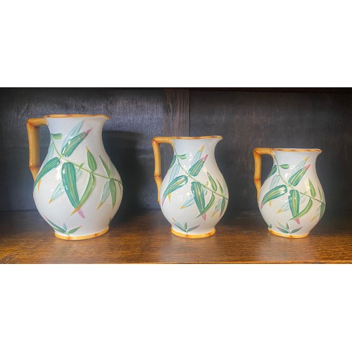 167 - A set of three 19th century majolica graduated jugs, each decorated with moulded bamboo handles and ... 