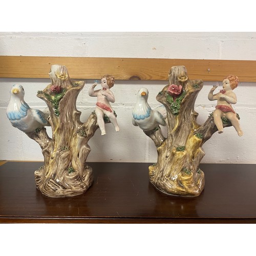 177 - A pair of continental lamp bases, each modelled as a dove and putto on tree stump -