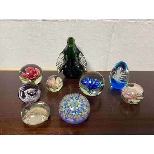 193 - A group of nine glass paperweights, including Wedgwood penguins -