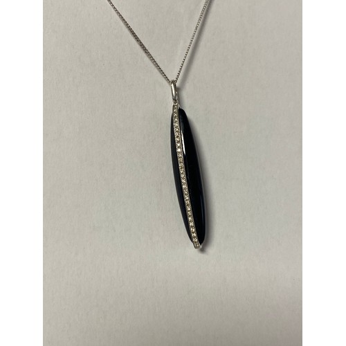 107 - A 9ct white gold, onyx and diamond set pendant, of torpedo shape, to 9ct white gold chain -