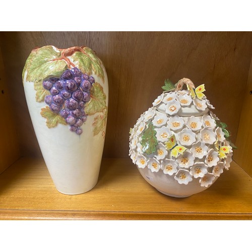 198 - A floral encrusted jar and cover, and a vase decorated with fruiting vines -