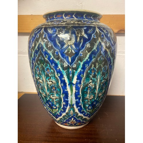 202 - An Iznik pottery vase, decorated with floral designs and lozenges on a turquoise and blue ground -