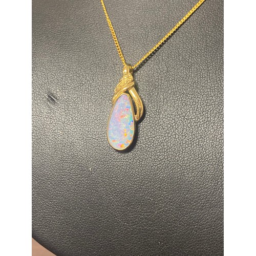 120 - An opal pendant, the mount stamped 18ct, to plated chain -