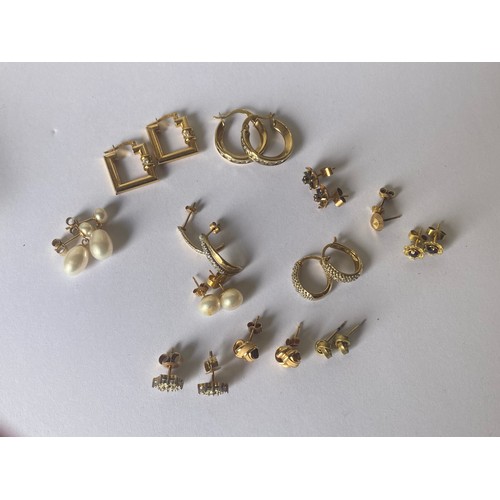 124 - An assortment of mostly 9ct gold earrings, some gem set -