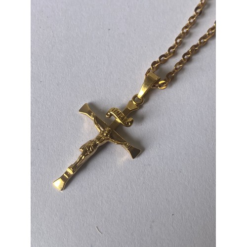 134 - An 18ct gold crucifix pendant to 9ct gold chain -