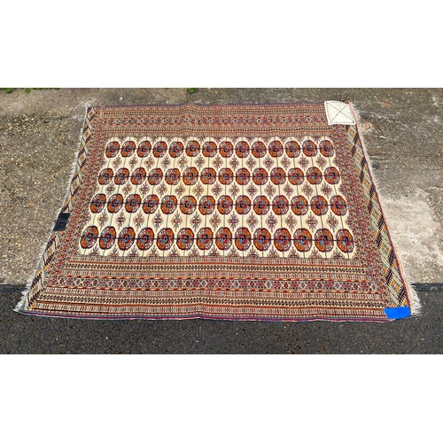 427 - A Pakistani rug, worked with a central panel with octagonal motifs within patterned guardstripe appr... 