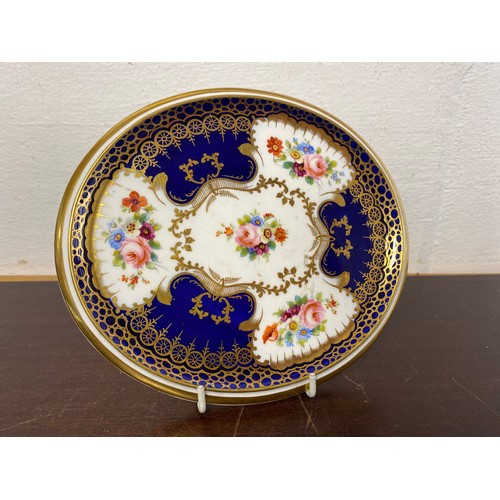 166A - A 19th century teapot stand, decorated with posies of flowers on a blue and gilt ground, printed and... 