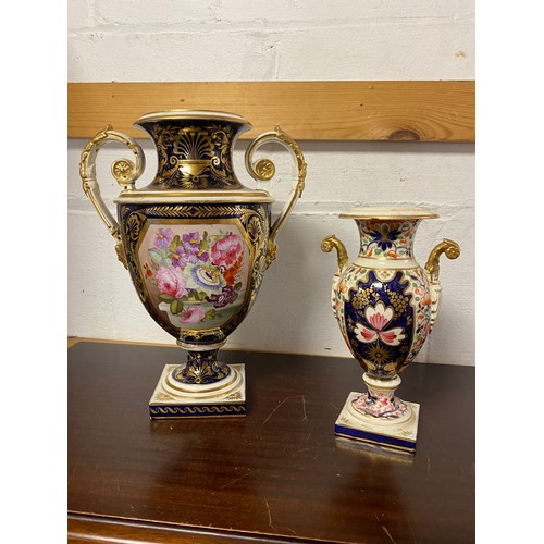 88 - A 19th century Derby twin handled vase, painted with a panel of flowers, with gilt highlights on a b... 