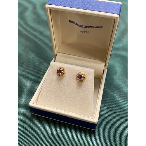 28 - A pair of 9ct gold and amethyst ear studs -