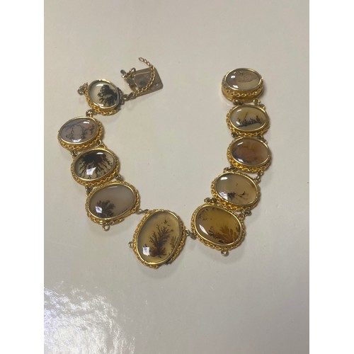 30 - A Victorian dendritic agate bracelet, composed of graduated oval panels in yellow metal frames, with... 