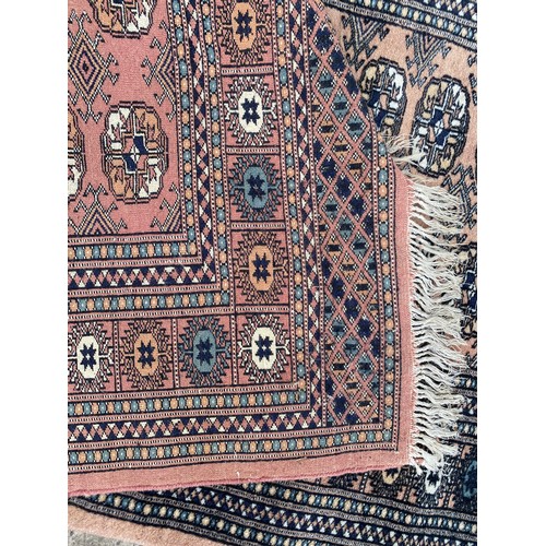 331 - A red rug approximately 160 x 120cm, another rug approximately 56 x 36cm and a runner approximately ... 