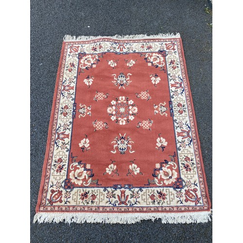 331 - A red rug approximately 160 x 120cm, another rug approximately 56 x 36cm and a runner approximately ... 