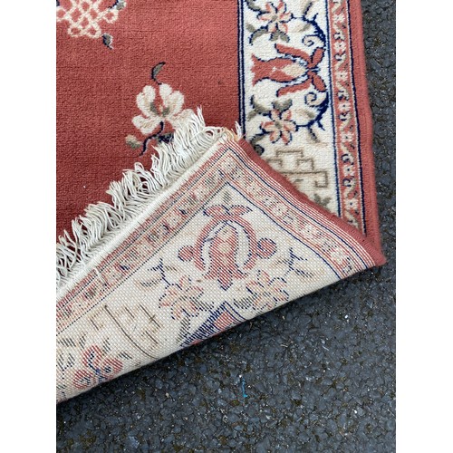 331 - A red rug approximately 160 x 120cm, another rug approximately 56 x 36cm and a runner approximately ... 