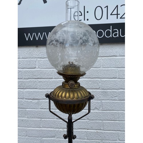 332 - An Arts & Crafts style floor standing oil lamp -