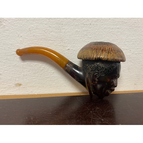 82 - An antique meerschaum pipe, the bowl realistically carved with a man's head, to amber mouthpiece -