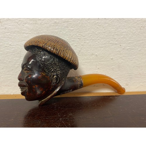 82 - An antique meerschaum pipe, the bowl realistically carved with a man's head, to amber mouthpiece -