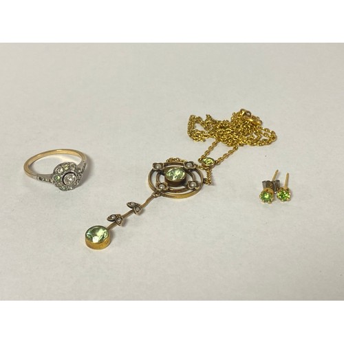 64 - An Edwardian peridot and seed pearl openwork pendant necklace, together with a pair of ear studs and... 