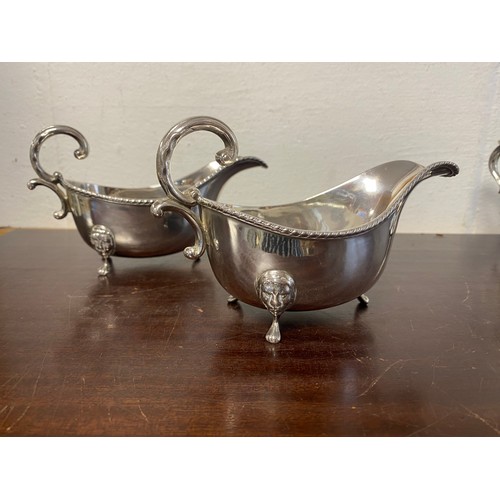 69 - A pair of Georgian style sauce boats, each raised on lion mask feet -