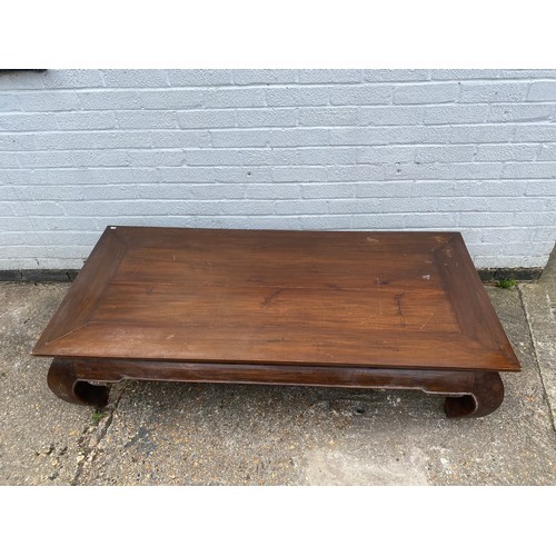 344 - A Chinese style hardwood low table, with rectangular top on shaped legs -