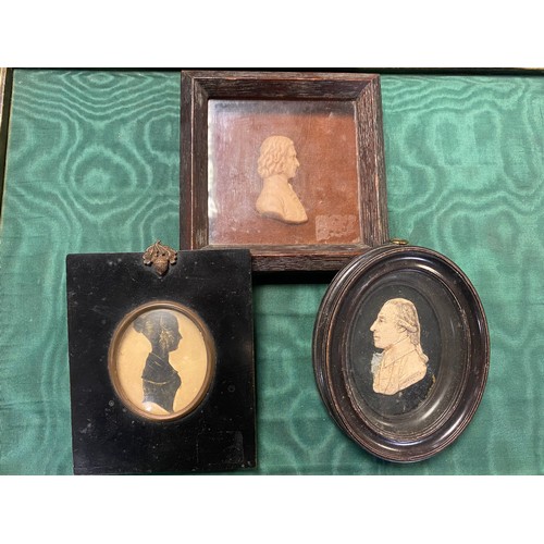 84A - A 19th century wax portrait of a man, initialled D A, together with a 19th century silhouette of a g... 