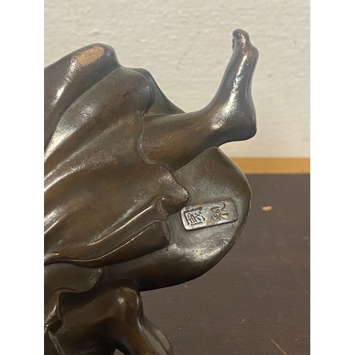61 - A Japanese bronze, depicting two figures, signed to the underside -