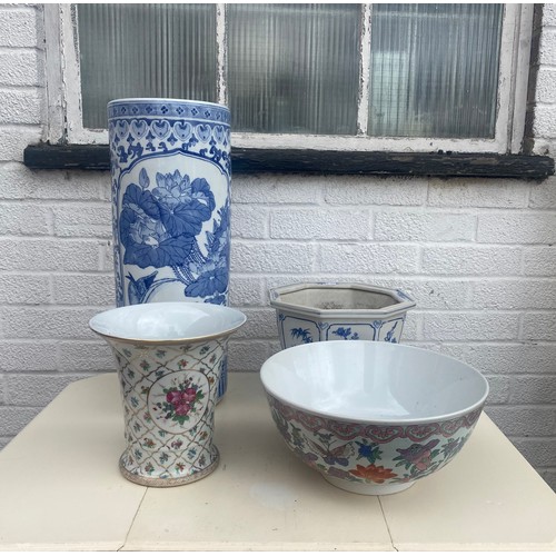 90 - A blue and white Chinese stick stand, a blue and white planter, modern famille rose punch bowl and a... 
