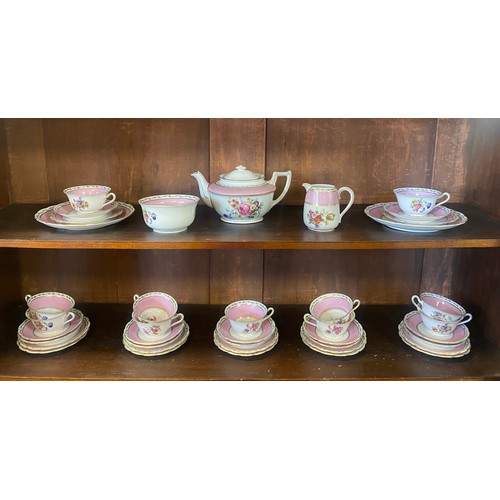 92 - A vintage tea set, each piece transfer decorated with flowers in a pink and gilded border -