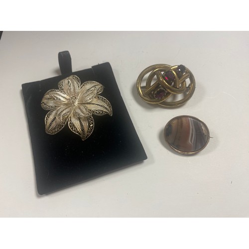 2 - A 19th century garnet set knotwork brooch, together with an agate brooch and a silver filigree flowe... 