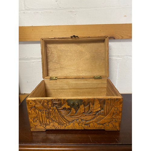54 - An eastern carved hardwood box, decorated with boats and landscapes -