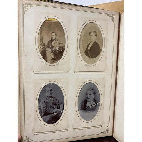 142 - A Victorian photograph album, containing approximately 100 carte de visites -