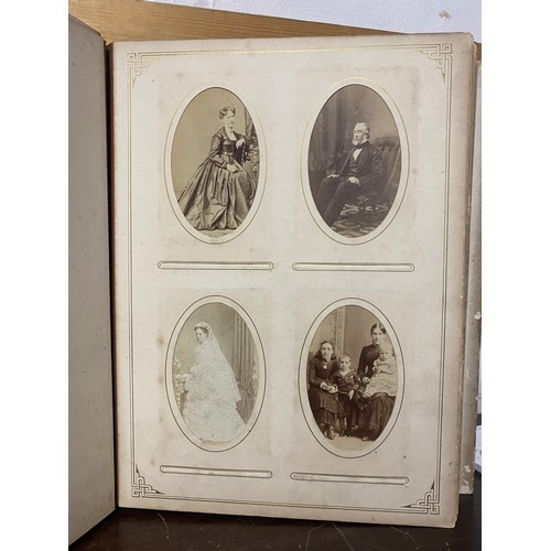 142 - A Victorian photograph album, containing approximately 100 carte de visites -