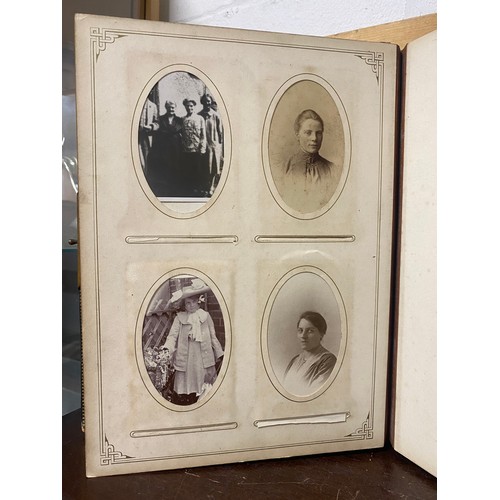 142 - A Victorian photograph album, containing approximately 100 carte de visites -