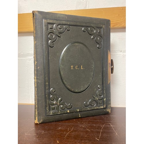 142 - A Victorian photograph album, containing approximately 100 carte de visites -