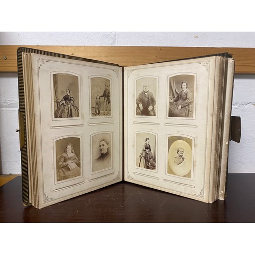 142 - A Victorian photograph album, containing approximately 100 carte de visites -