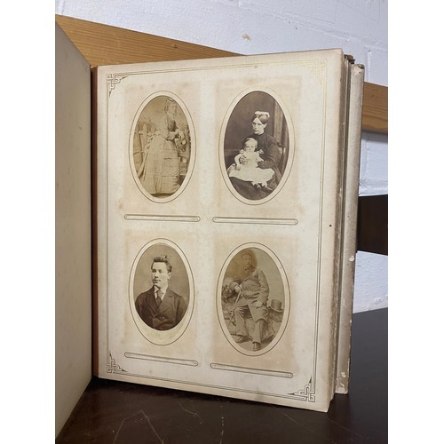 142 - A Victorian photograph album, containing approximately 100 carte de visites -