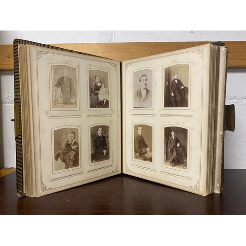 142 - A Victorian photograph album, containing approximately 100 carte de visites -