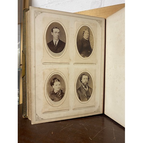 142 - A Victorian photograph album, containing approximately 100 carte de visites -