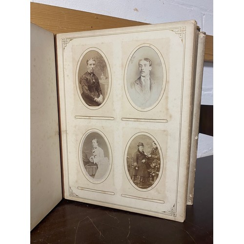 142 - A Victorian photograph album, containing approximately 100 carte de visites -