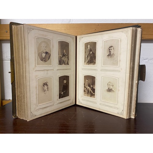 142 - A Victorian photograph album, containing approximately 100 carte de visites -