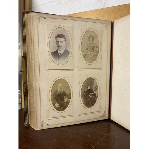 142 - A Victorian photograph album, containing approximately 100 carte de visites -