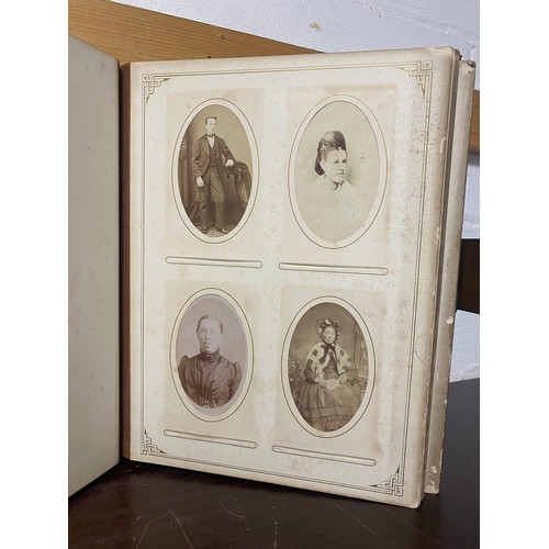 142 - A Victorian photograph album, containing approximately 100 carte de visites -