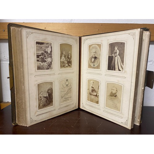 142 - A Victorian photograph album, containing approximately 100 carte de visites -